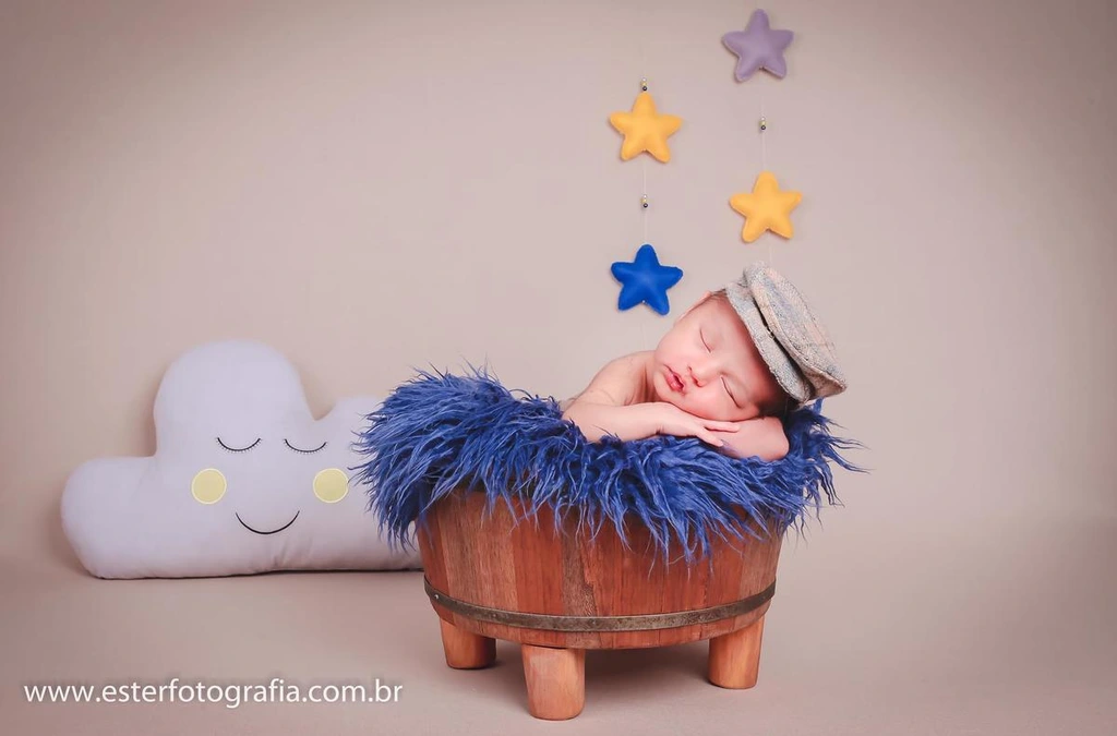 Bebê em cenário com estrelas e nuvem em tons azuis